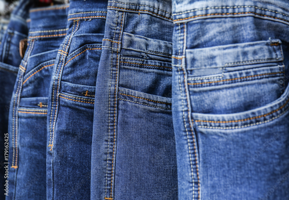 Rack with different jeans in modern shop Rack with different jeans in modern shop