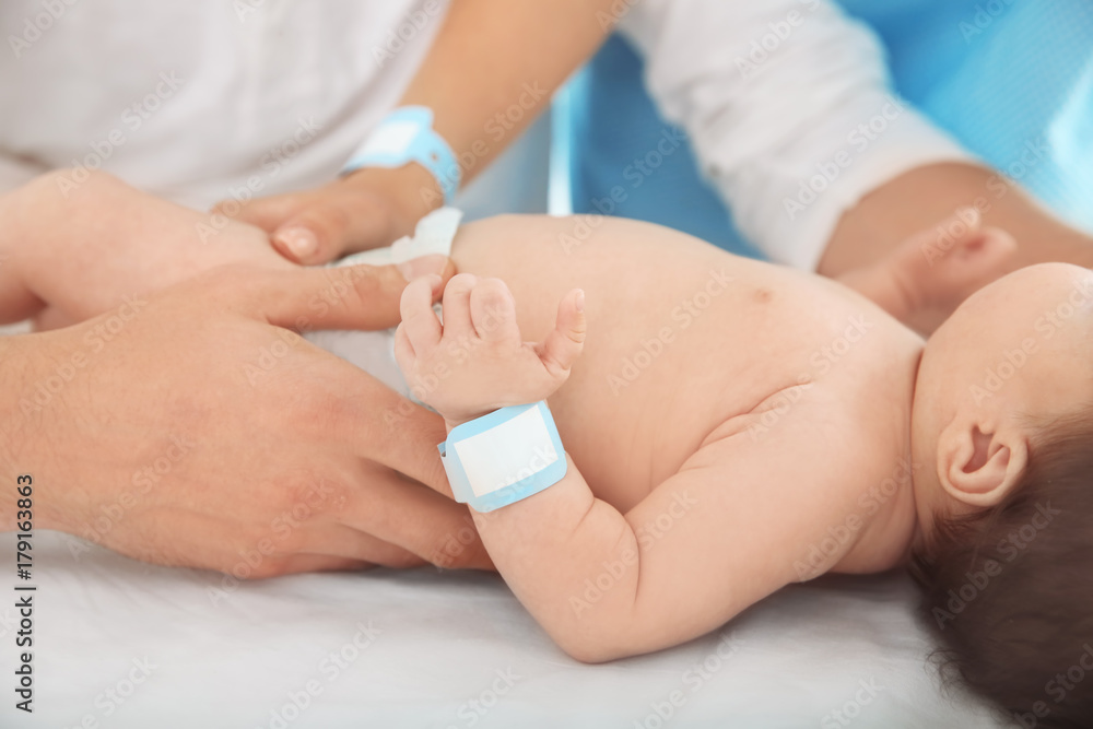 Happy young family with cute baby at hospital Happy young family with cute baby at hospital