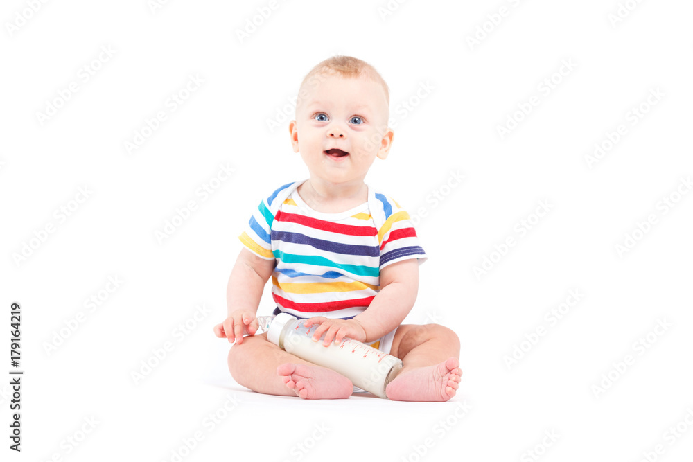 cute joyful baby boy in colorful shirt hold milk bottle cute joyful baby boy in colorful shirt hold milk bottle