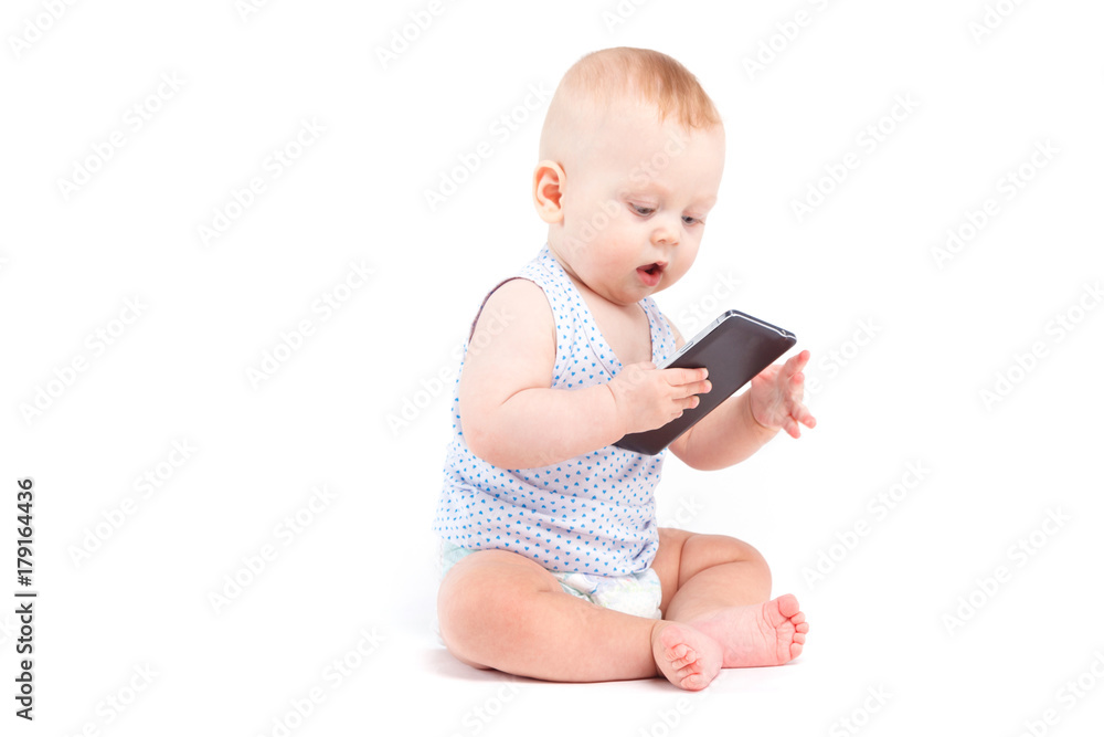 cute joyful baby boy in blue shirt and diaper hold cellphone