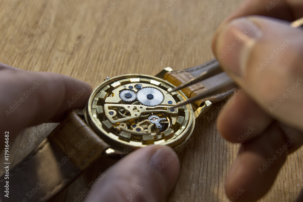 Watchmaker is repairing the mechanical watches in his workshop Watchmaker is repairing the mechanical watches in his workshop