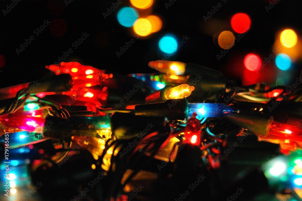 Christmas glowing electric garland with lights on a bokeh background Christmas glowing electric garland with lights on a bokeh background