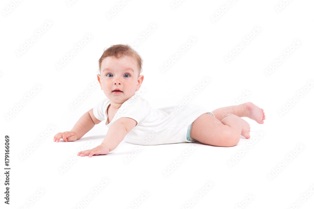 cute pretty baby boy in white shirt lies on tummy cute pretty baby boy in white shirt lies on tummy