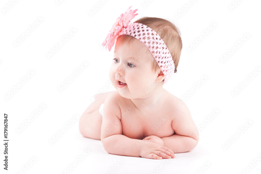 beautiful cute baby girl in pink flower wrap lies on tummy beautiful cute baby girl in pink flower wrap lies on tummy