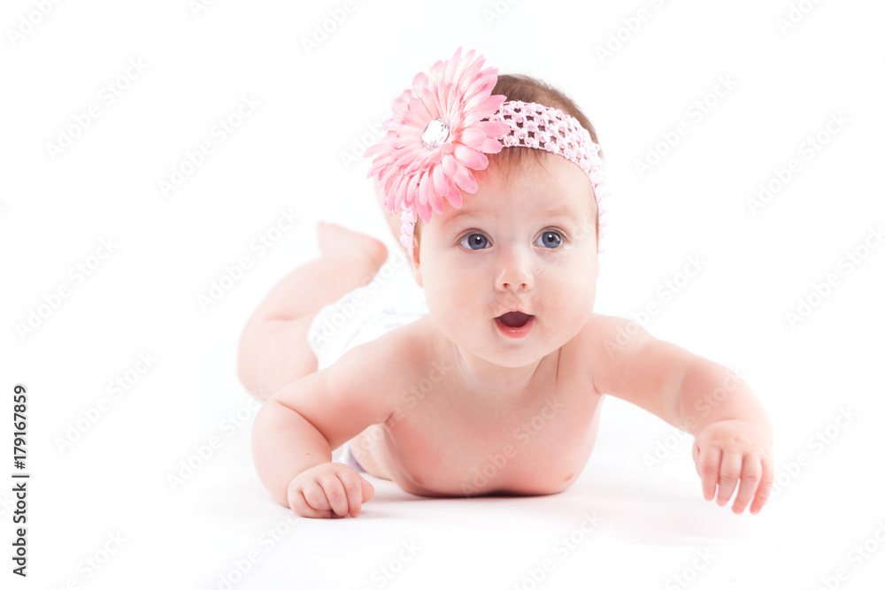 beautiful cute baby girl in pink flower wrap lies on tummy beautiful cute baby girl in pink flower wrap lies on tummy