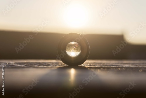 dslr camera lens on table with sunset light