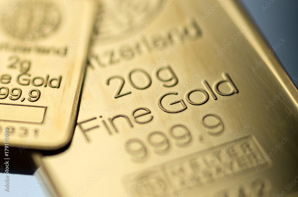 The surface of small minted gold bar. Selective focus. The surface of small minted gold bar. Selective focus.