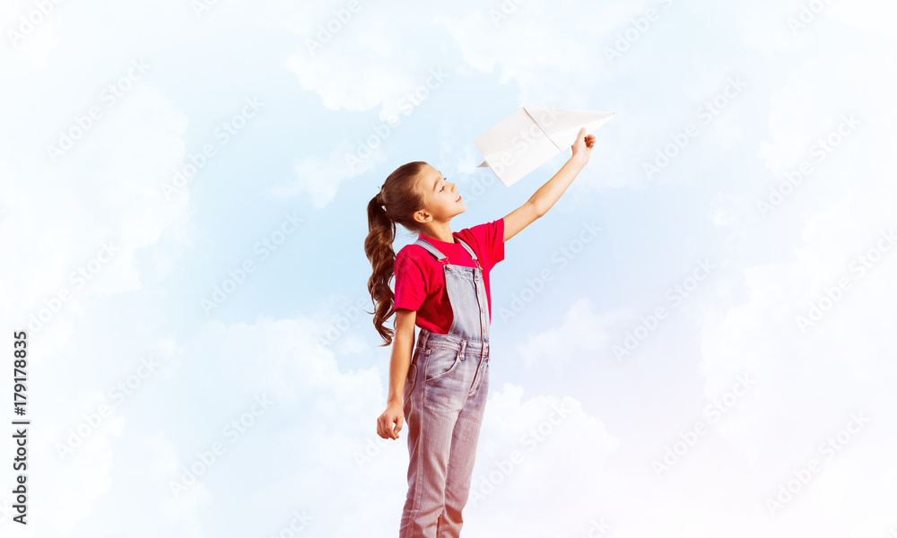 Concept of careless happy childhood with girl dreaming to become pilot Concept of careless happy childhood with girl dreaming to become pilot