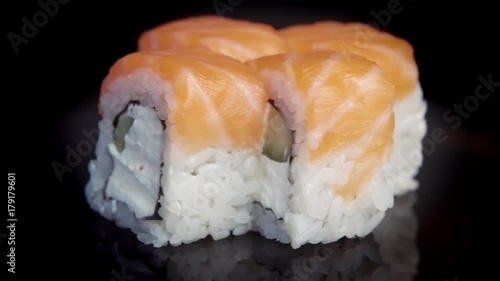 Wallpaper Mural Sushi philadelphia roll rotates on the black background Torontodigital.ca