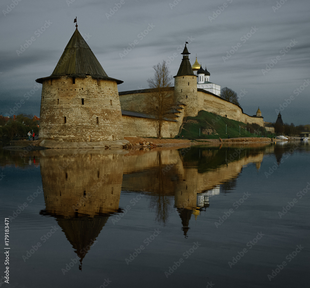 Old fortress in Pskov with its reflection in the water