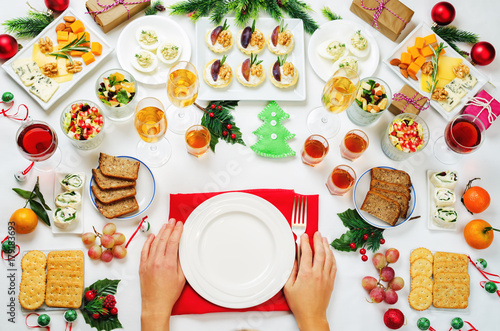 Christmas appetizers celebration table setting with woman's hands
