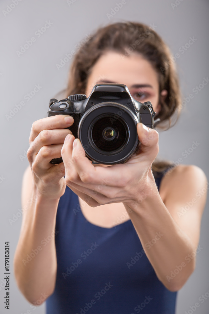 Pretty woman is a professional photographer with camera Pretty woman is a professional photographer with camera