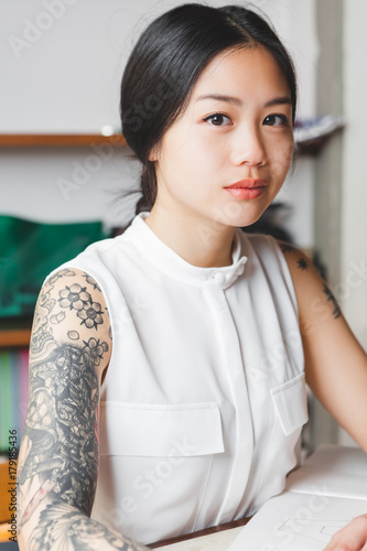 Portrait of young woman with tattoo sleeve