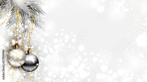 light Christmas background with two holiday evening balls and branch of fir tree