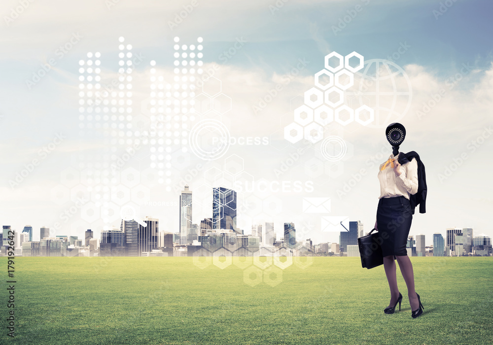 Camera headed woman standing on green grass against modern citys Camera headed woman standing on green grass against modern citys