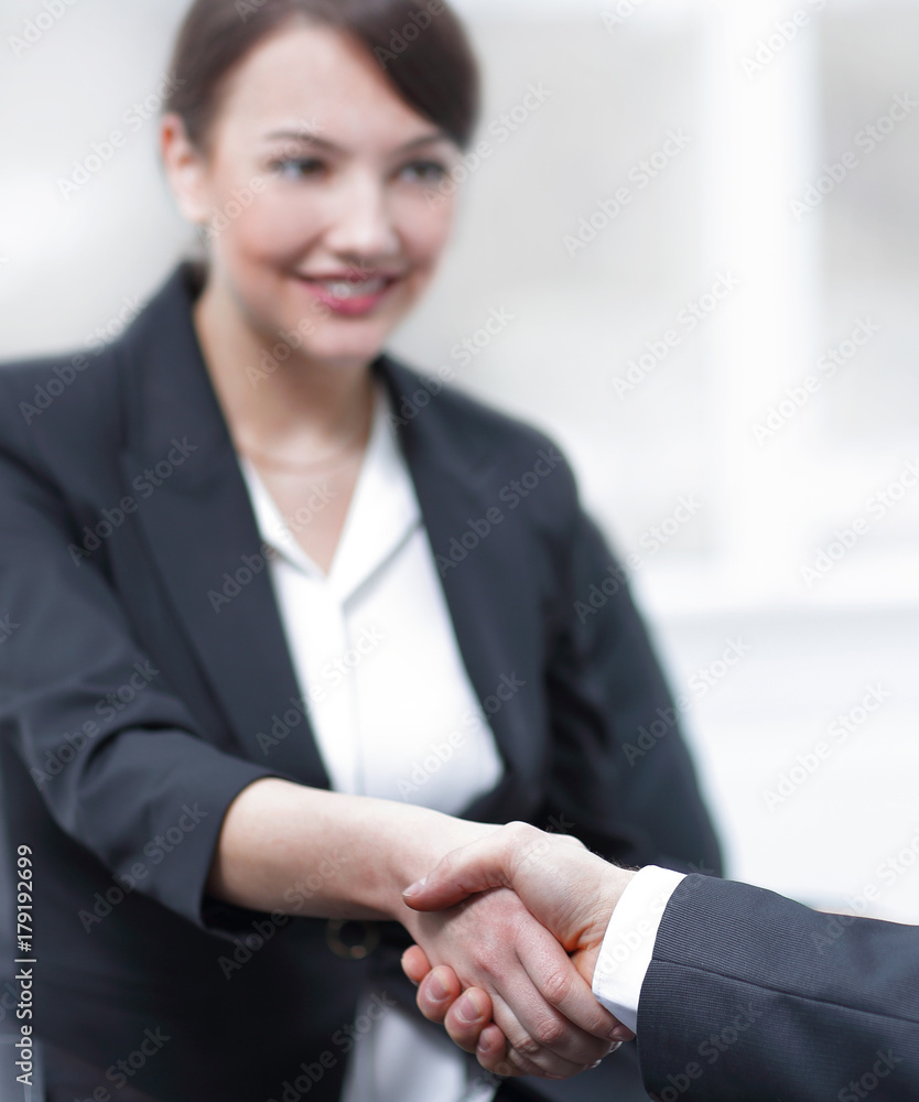 closeup of business woman shaking hands with her colleague. closeup of business woman shaking hands with her colleague.