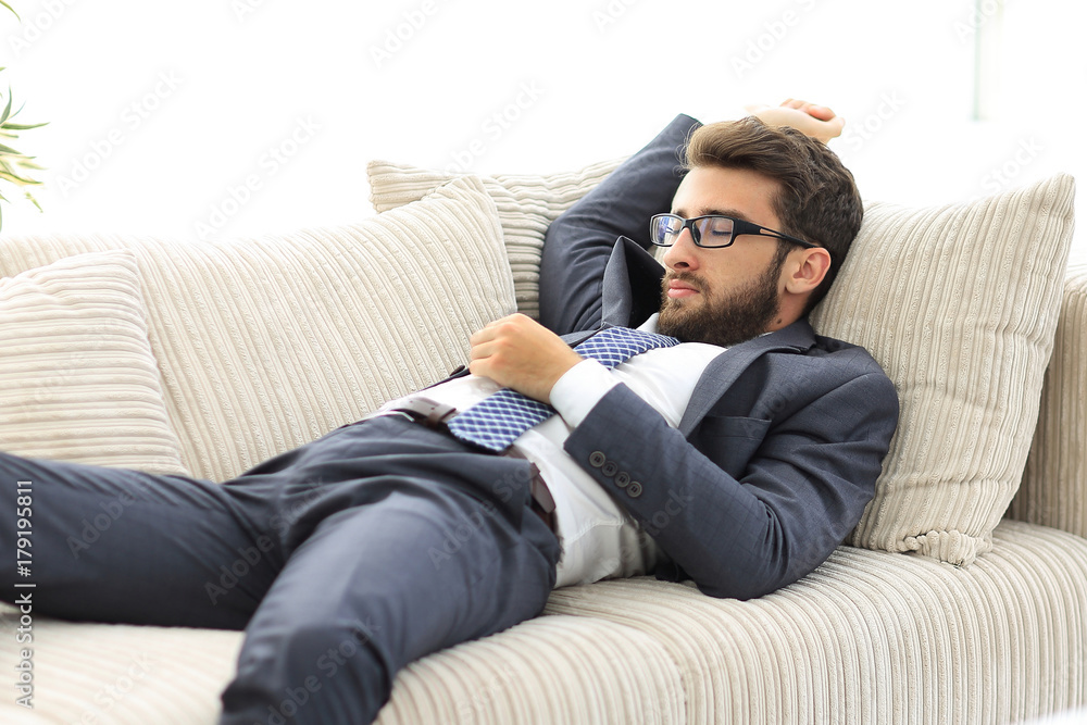 tired businesswoman relaxing on the couch. tired businesswoman relaxing on the couch.