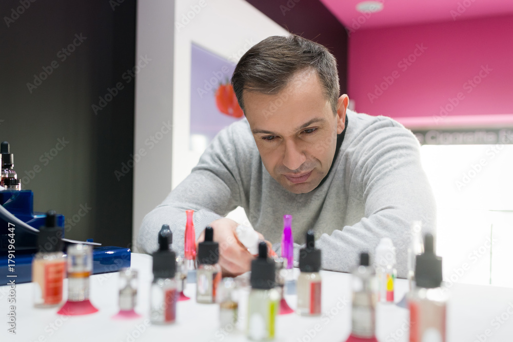 man choosing electronic cigarette man choosing electronic cigarette