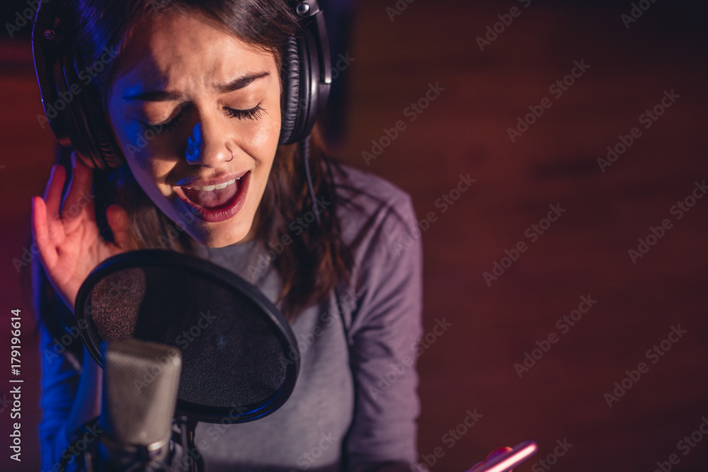 Singer singing a song in the recording studio Singer singing a song in the recording studio
