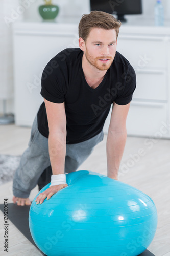 happy attractive sporty handsome man doing push ups exercises