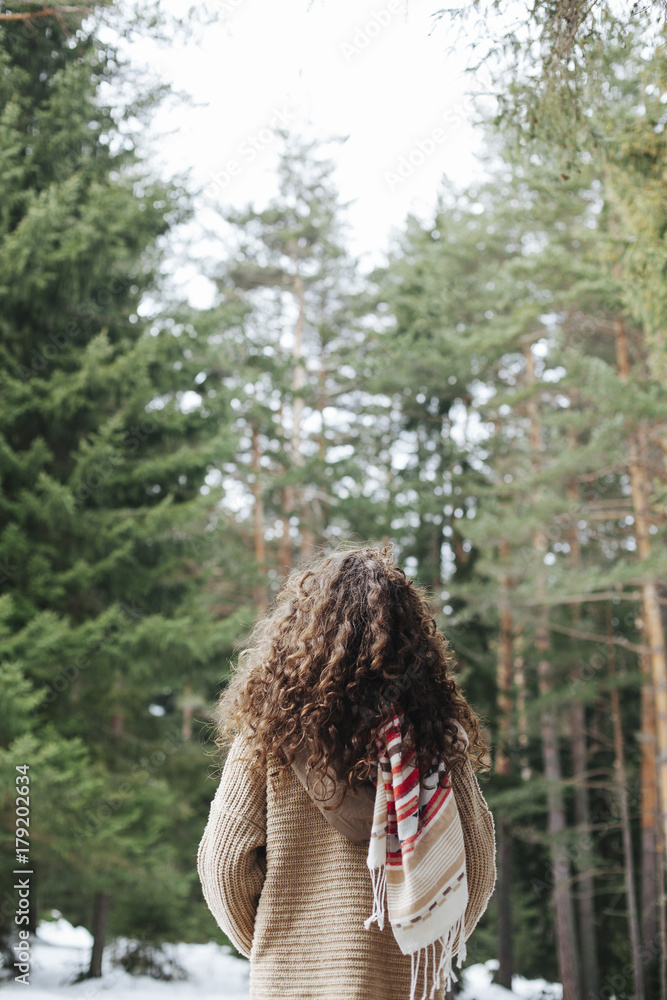 View from the back of a young woman in the mountain View from the back of a young woman in the mountain