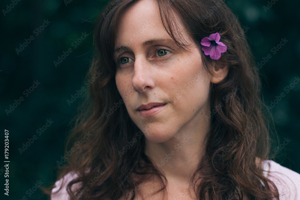 Close up of woman with flower in her hair Close up of woman with flower in her hair