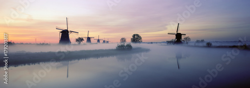 Netherlands, Europe, Holland, Zuid Holland, Row of Windmills and canal, Kinderdijk photo
