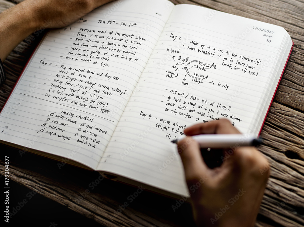 Fototapeta premium Closeup of hands writing travel plan