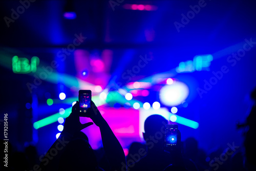 Audience recording footage with smartphone during a concert