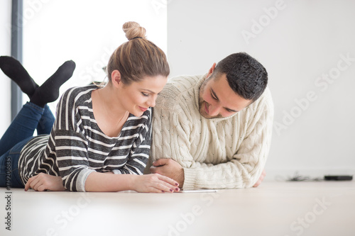 Young Couple using digital tablet on cold winter day