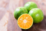 Green tangerine orange fruit on wooden background, healthy fruit