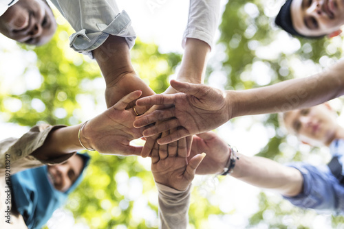 Group of diverse youth with teamwork joined hands photo