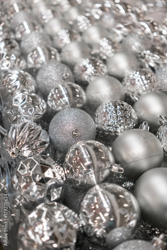 Variety of silver christmas balls in clear transparent plastic package.
