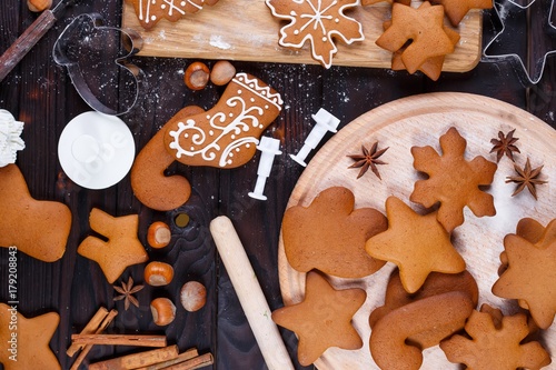 Christmas bakery. Freshly baked homemade gingerbread cookies, cutters, baking utensils and food decorations on the table, flat lay.Family festive culinary and New Year traditions concept