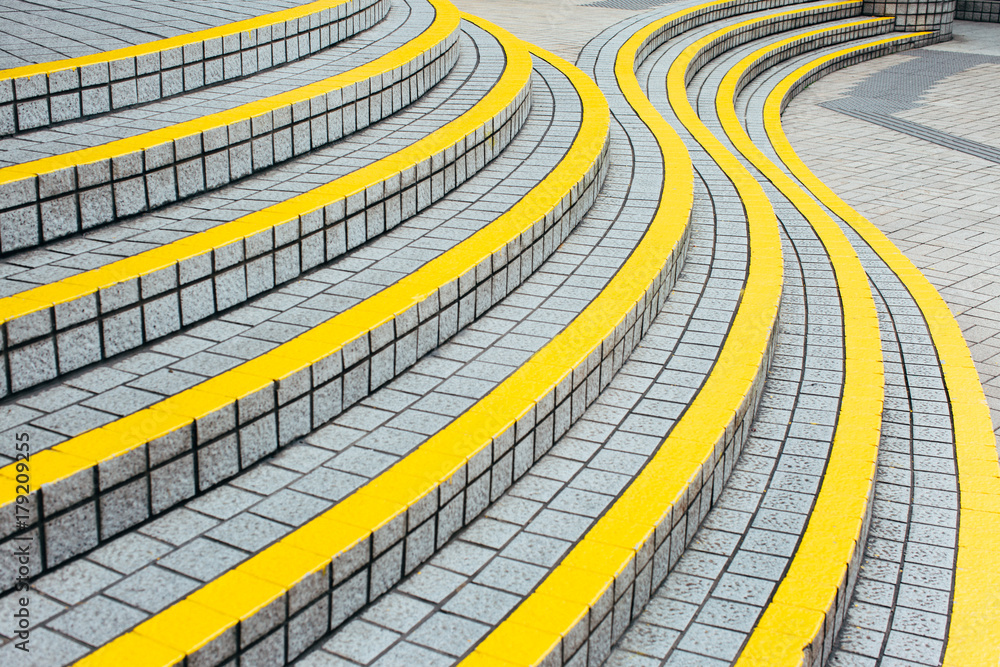 Curved stairway with yellow demarcation lines Stock Photo | Adobe Stock