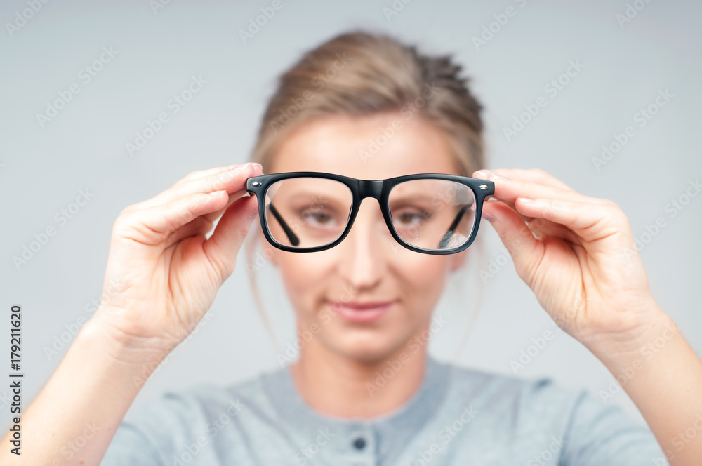 Woman optician with eyeglasses and frame in focus. Woman optician with eyeglasses and frame in focus.