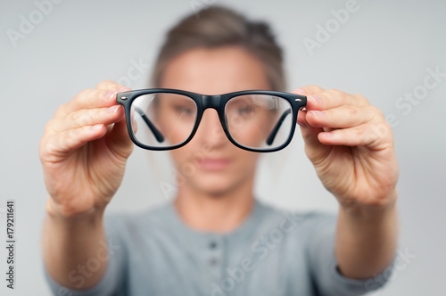 Woman optician with eyeglasses and frame in focus.