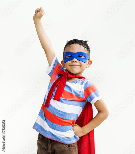 Little boy playing superhero at the playground