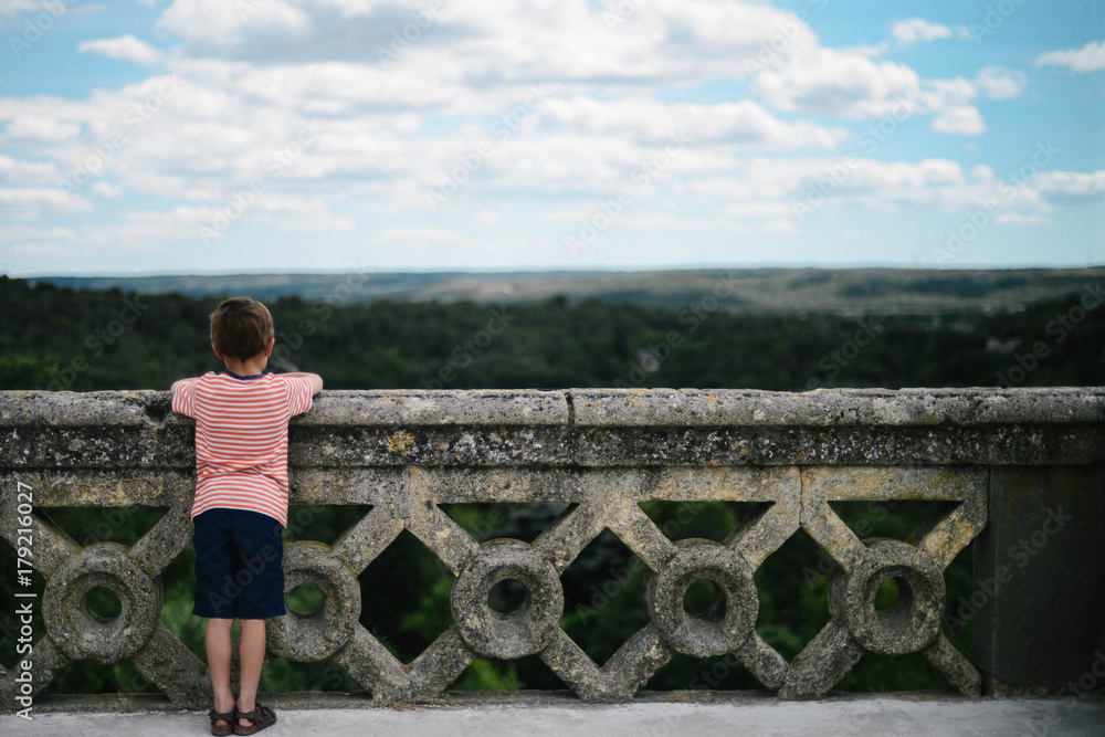 Caucasian boy looking out over view in France. Caucasian boy looking out over view in France.