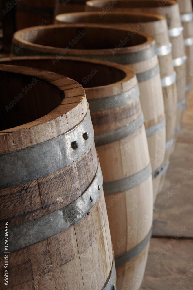 Hoops and rivets on lined up oakwood barrels Hoops and rivets on lined up oakwood barrels