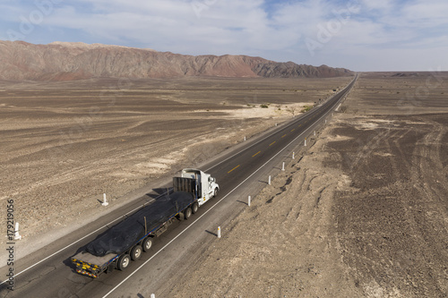 Panamericana Sur with truck, stretches away across Nazca desert Peru photo