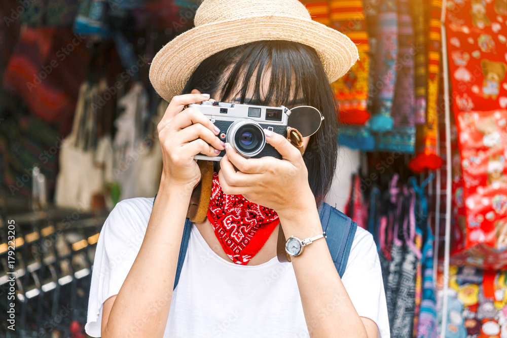 Asian woman taking picture with camera Asian woman taking picture with camera