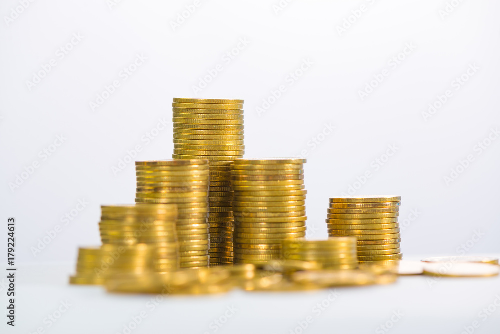 Columns of gold coins, piles of coins on white background Columns of gold coins, piles of coins on white background