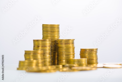 Columns of gold coins, piles of coins on white background