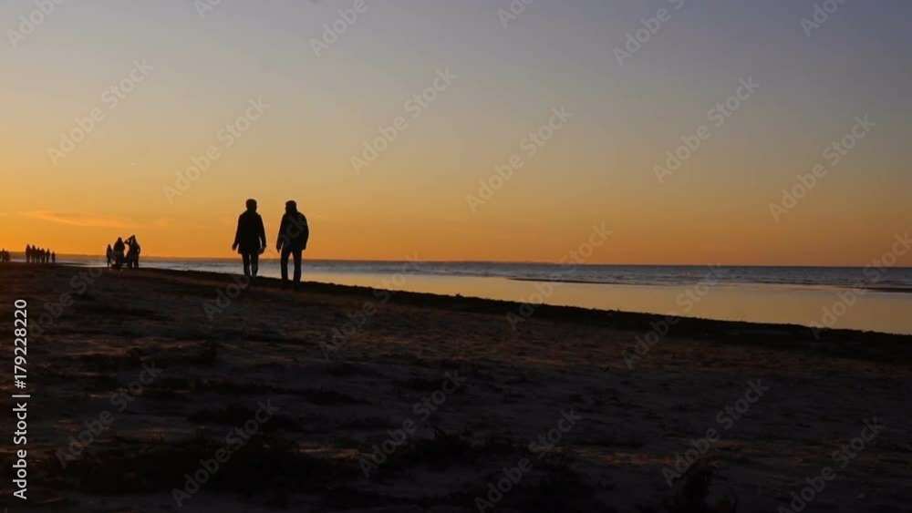 Happy family walking on sea coast. Silhouettes sunset. Happy family walking on sea coast. Silhouettes sunset.