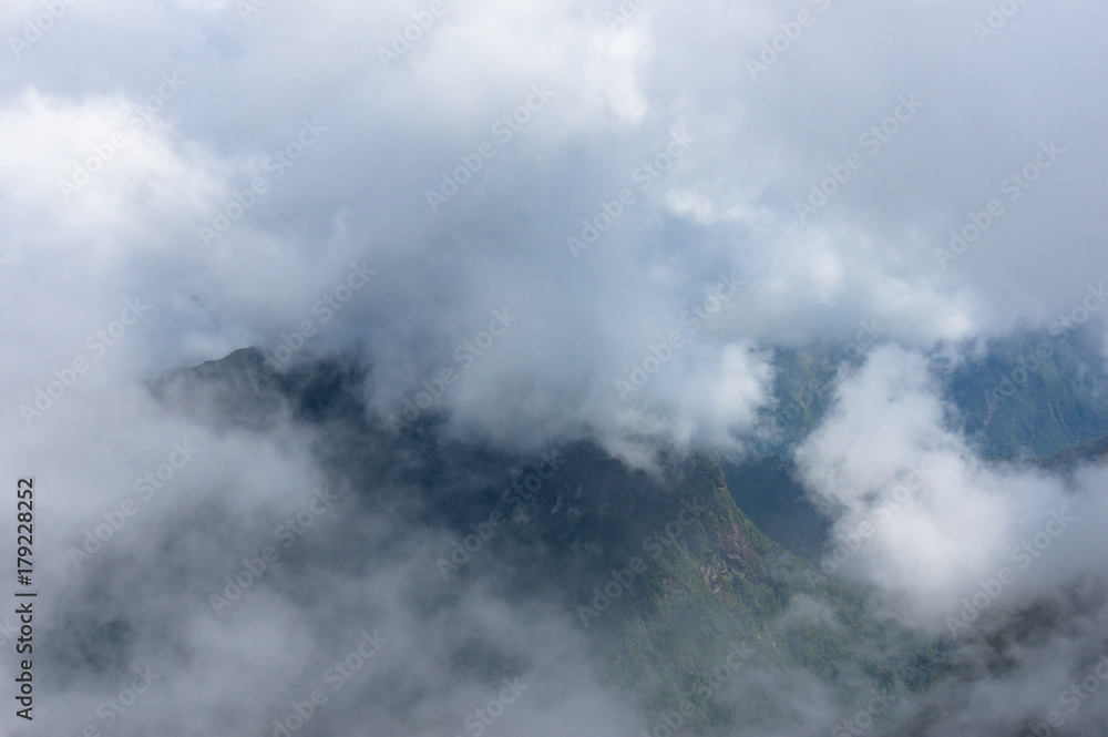 Aerial view on mountain peaks through cloud Aerial view on mountain peaks through cloud