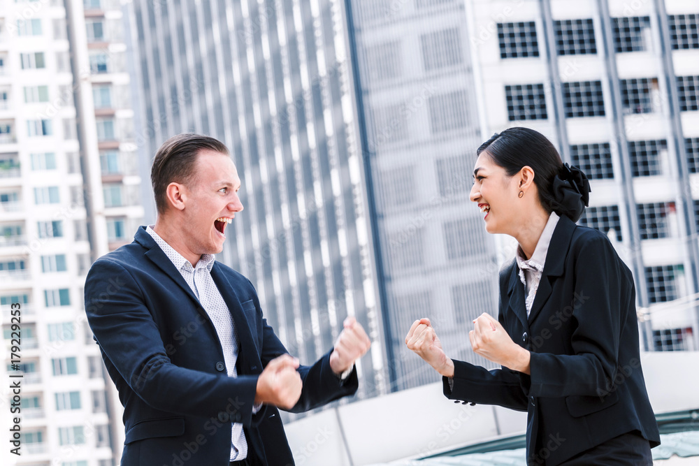 Successful business people celebrating with arms up Successful business people celebrating with arms up