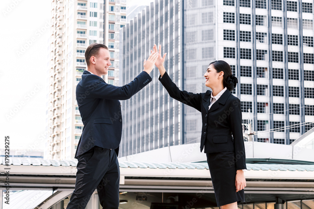 Successful of business people giving a high fives gesture Successful of business people giving a high fives gesture
