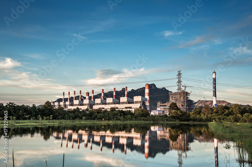 Coal power plant at water front with reflection