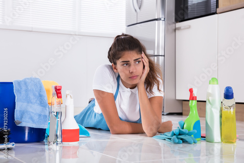 Bild auf Leinwand Tired Woman Lying On Kitchen Floor